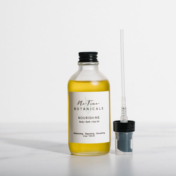 Bottle of Nourish Hair product with a spray nozzle on a white background