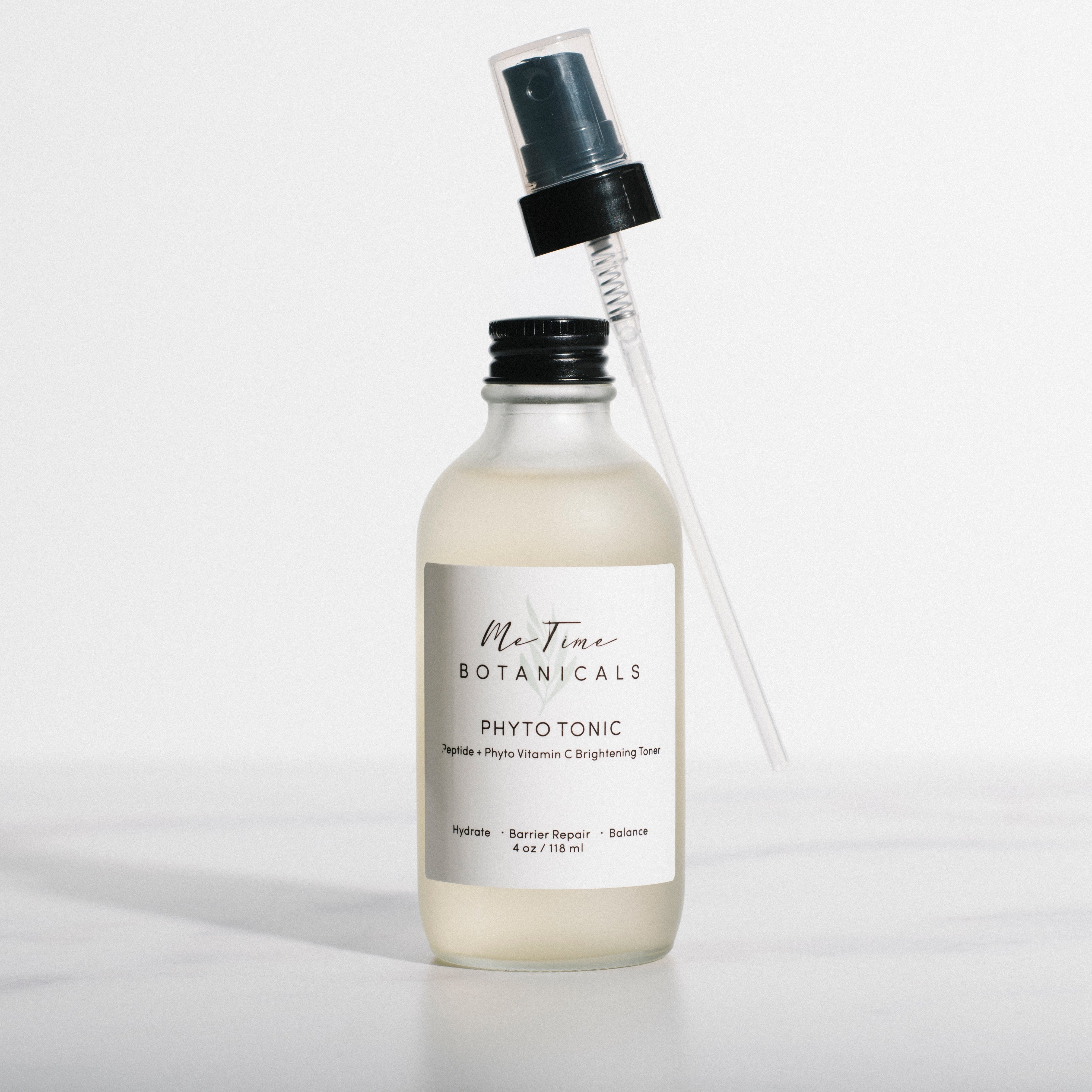 Bottle of 'Ma Tiare Botanicals Phyto Tonic' with a spray nozzle on a light gray background