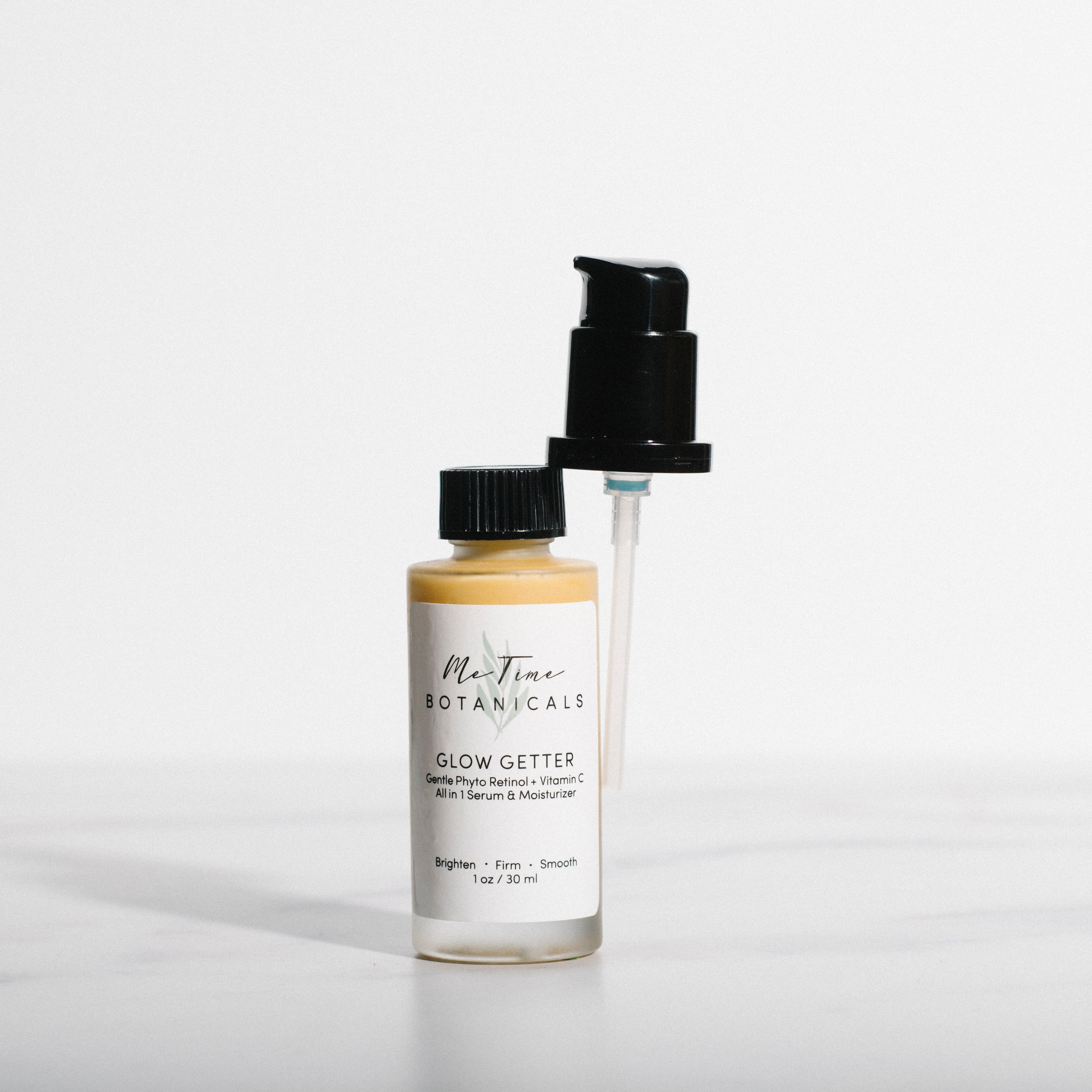 Two skincare bottles with labels on a light gray background