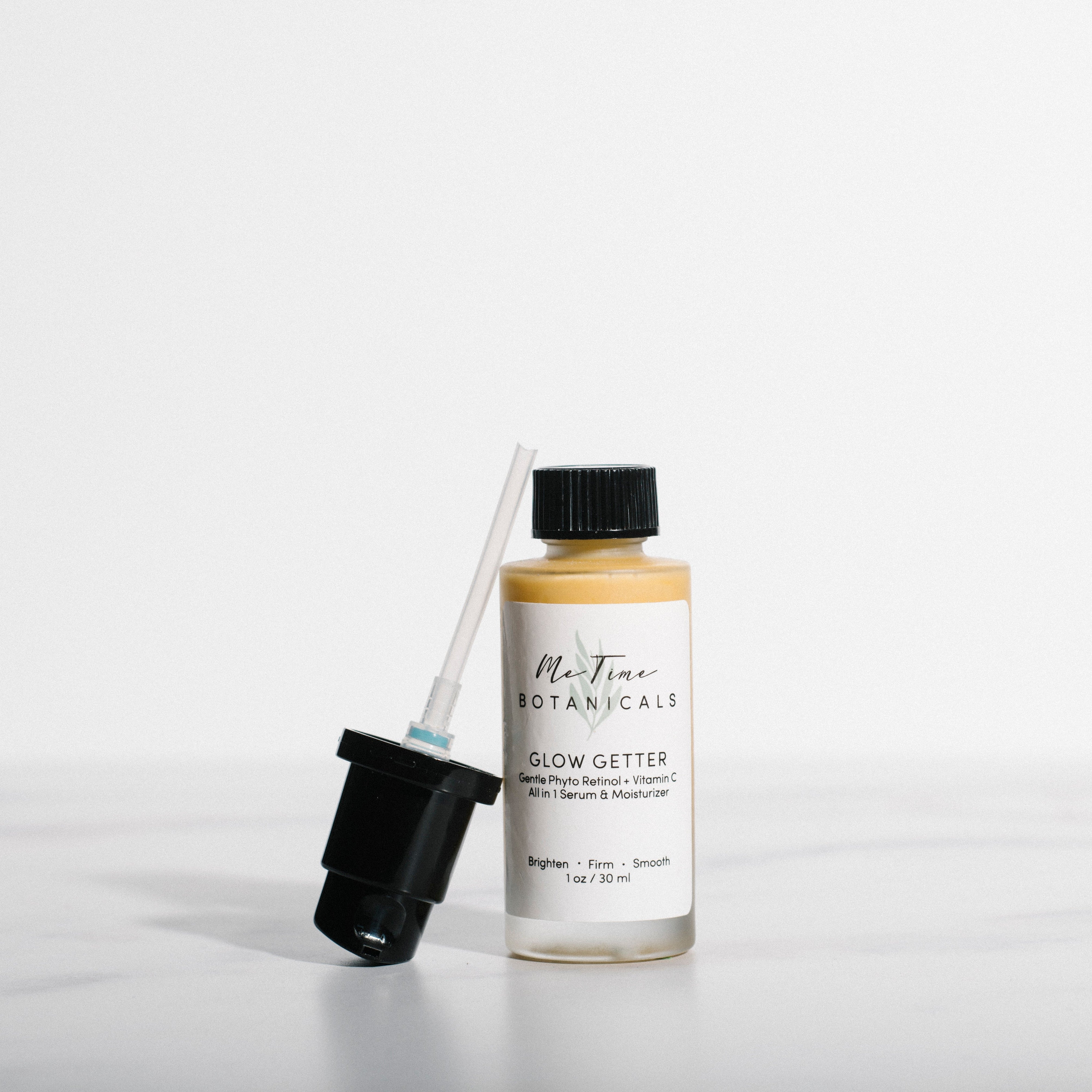 Bottle of Glow Getter with dropper on a white background