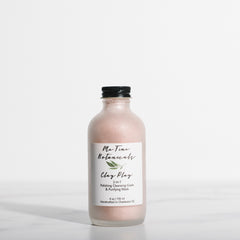 Bottle of clay mask with a label on a white background