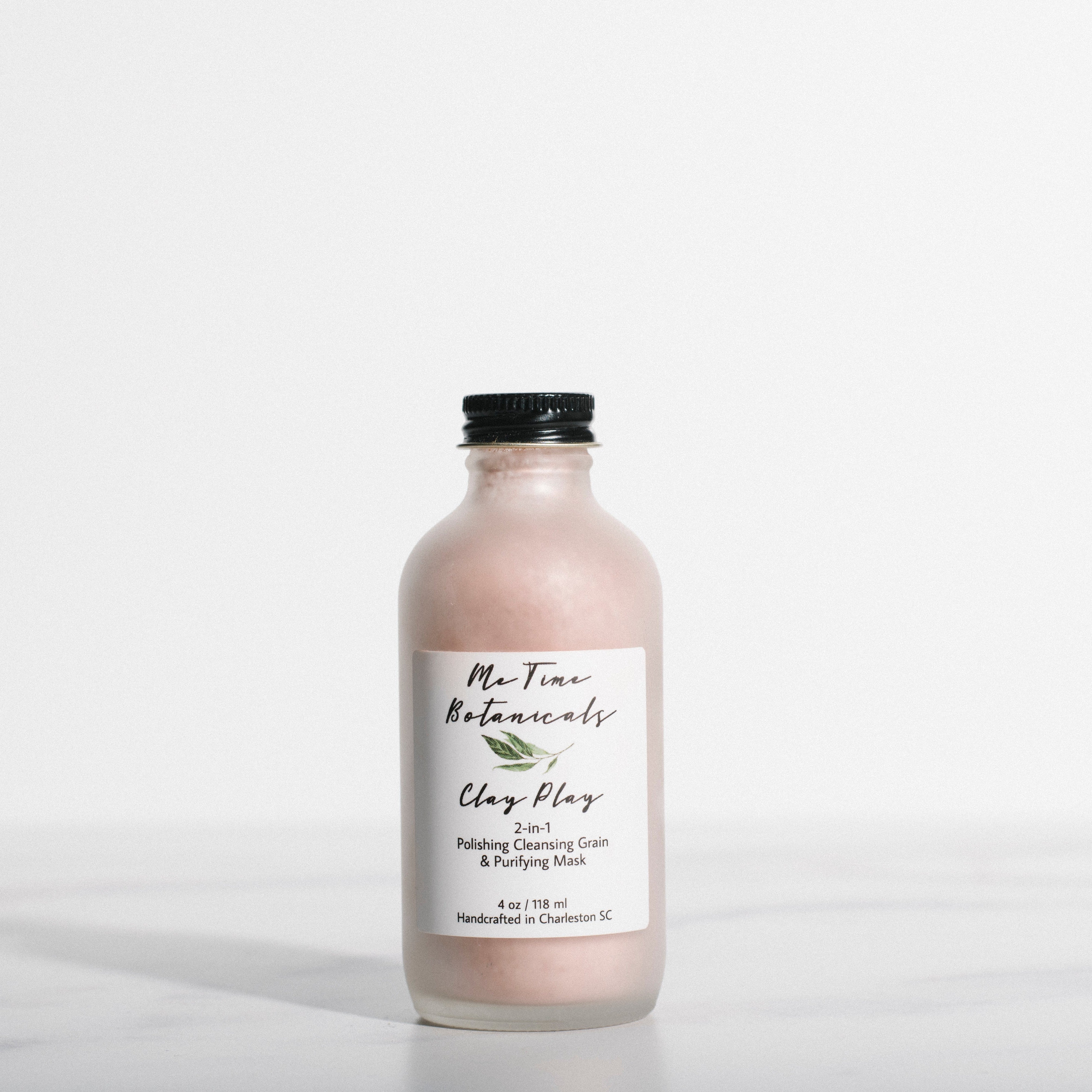 Bottle of clay mask with a label on a white background