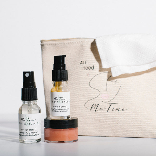 Skincare products and pouch with 'Me Time Botanicals' branding on a light background