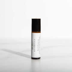 White rollerball bottle with black cap on a white background