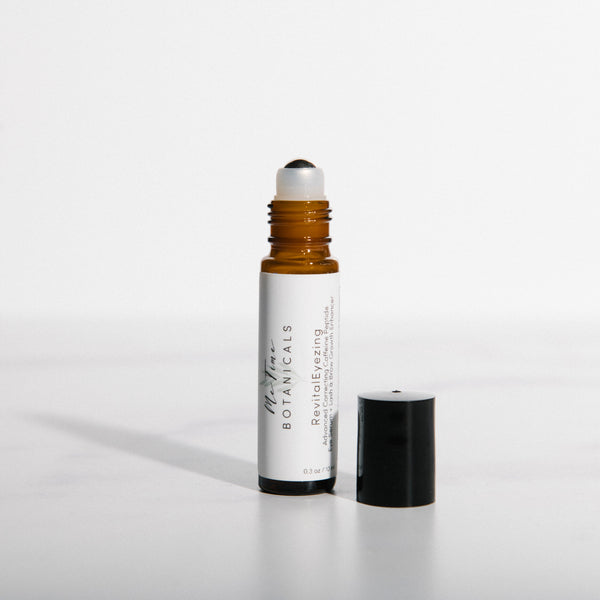 White rollerball bottle with black cap on a white background
