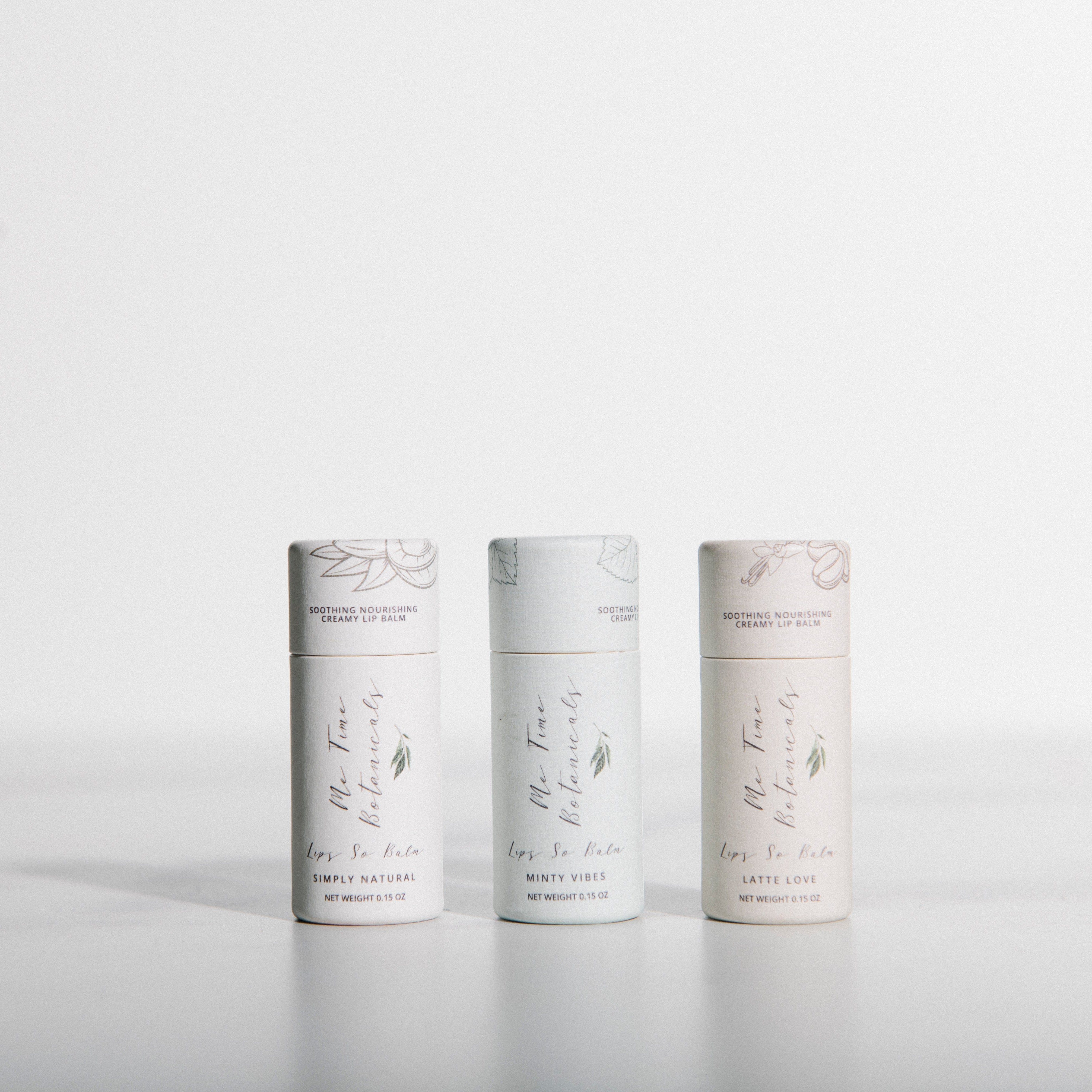 Three cylindrical white products with text on a light gray background