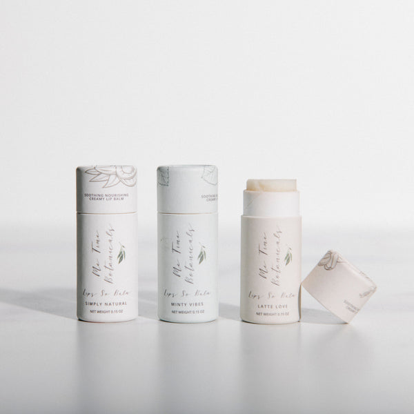 Three cylindrical white products with text on a light gray background