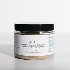 Jar of 'BUFF' body scrub with a white label on a white background