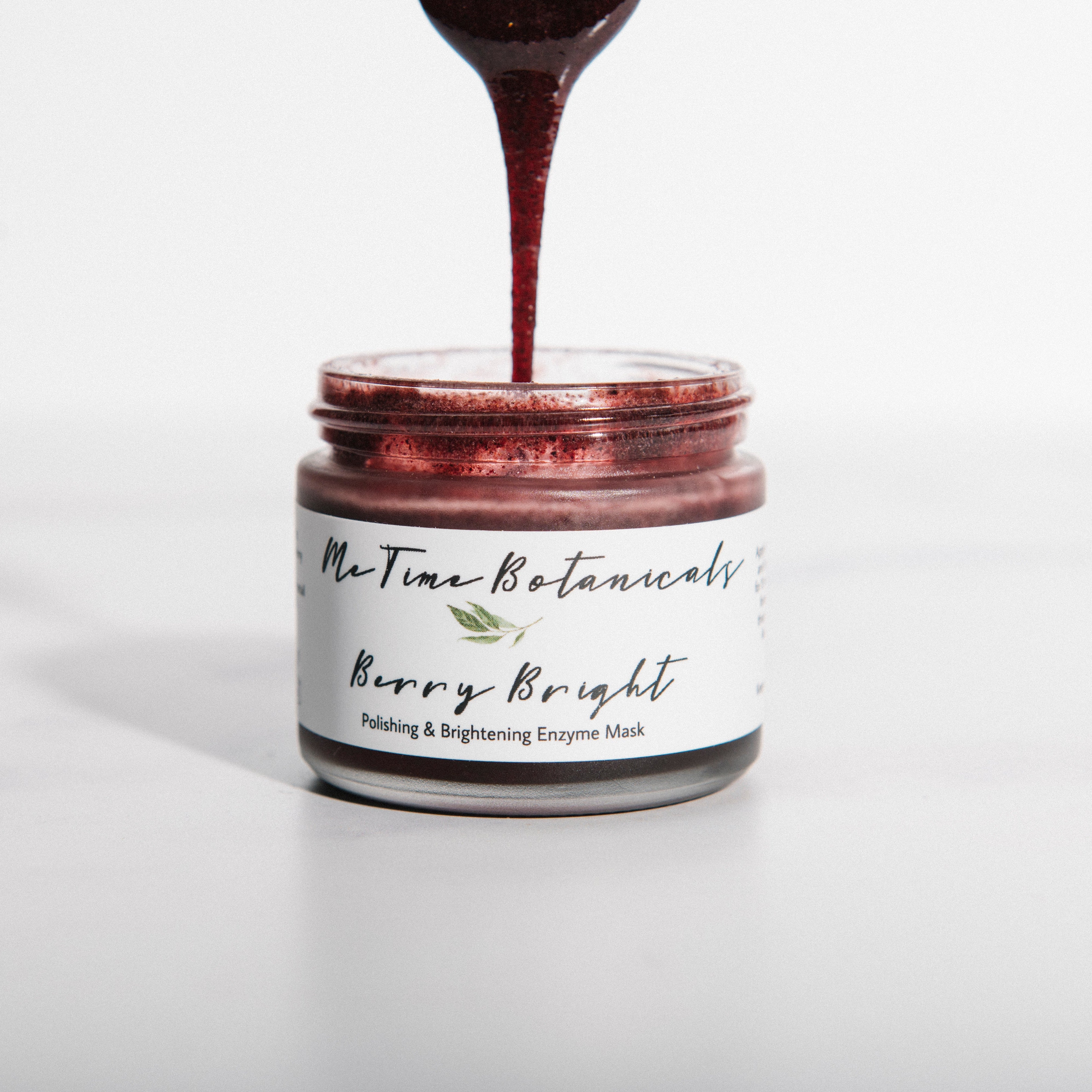 Jar of 'Berry Bright' product with a label, being poured into it.