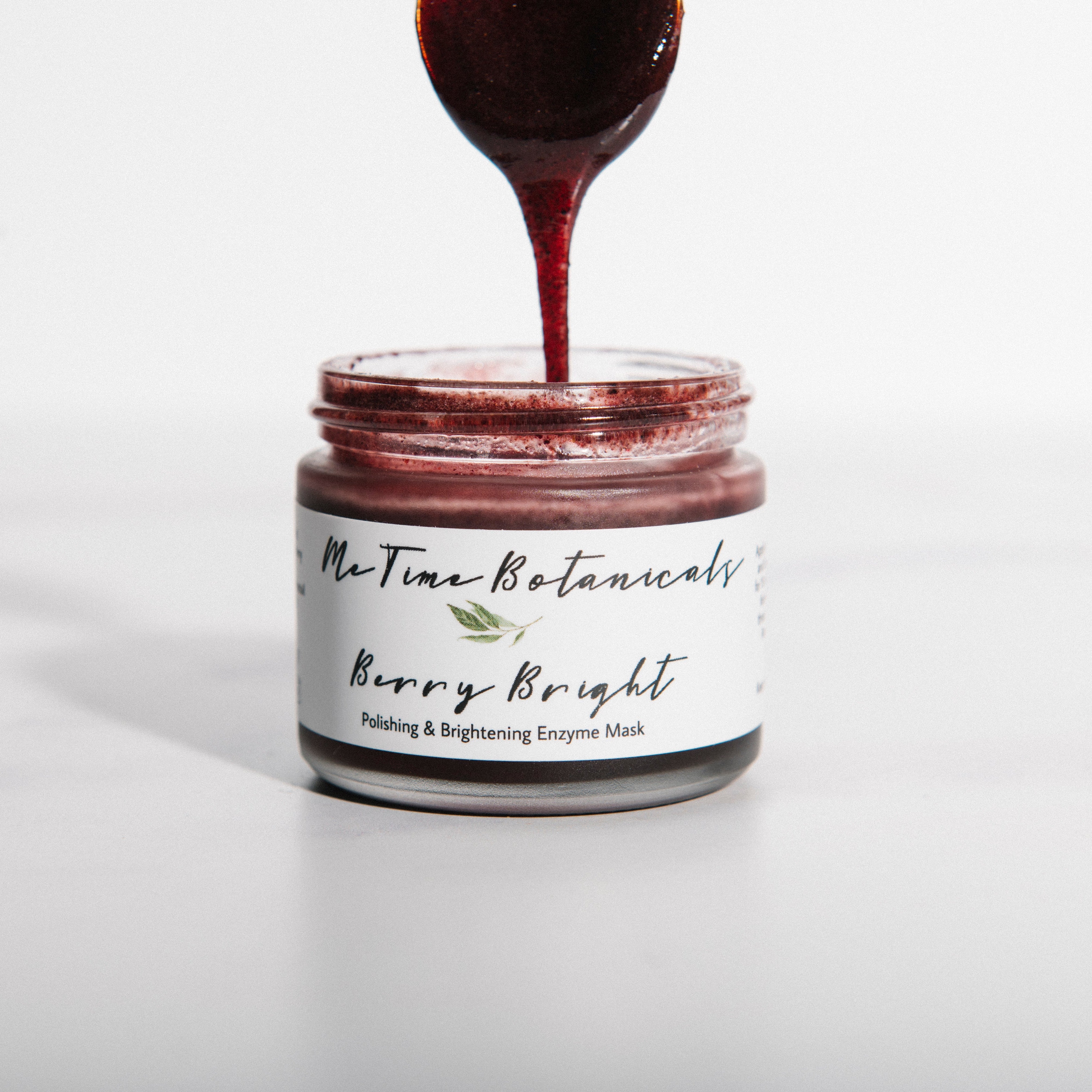 Jar of 'Berry Bright' product with a spoonful being poured, on a white background