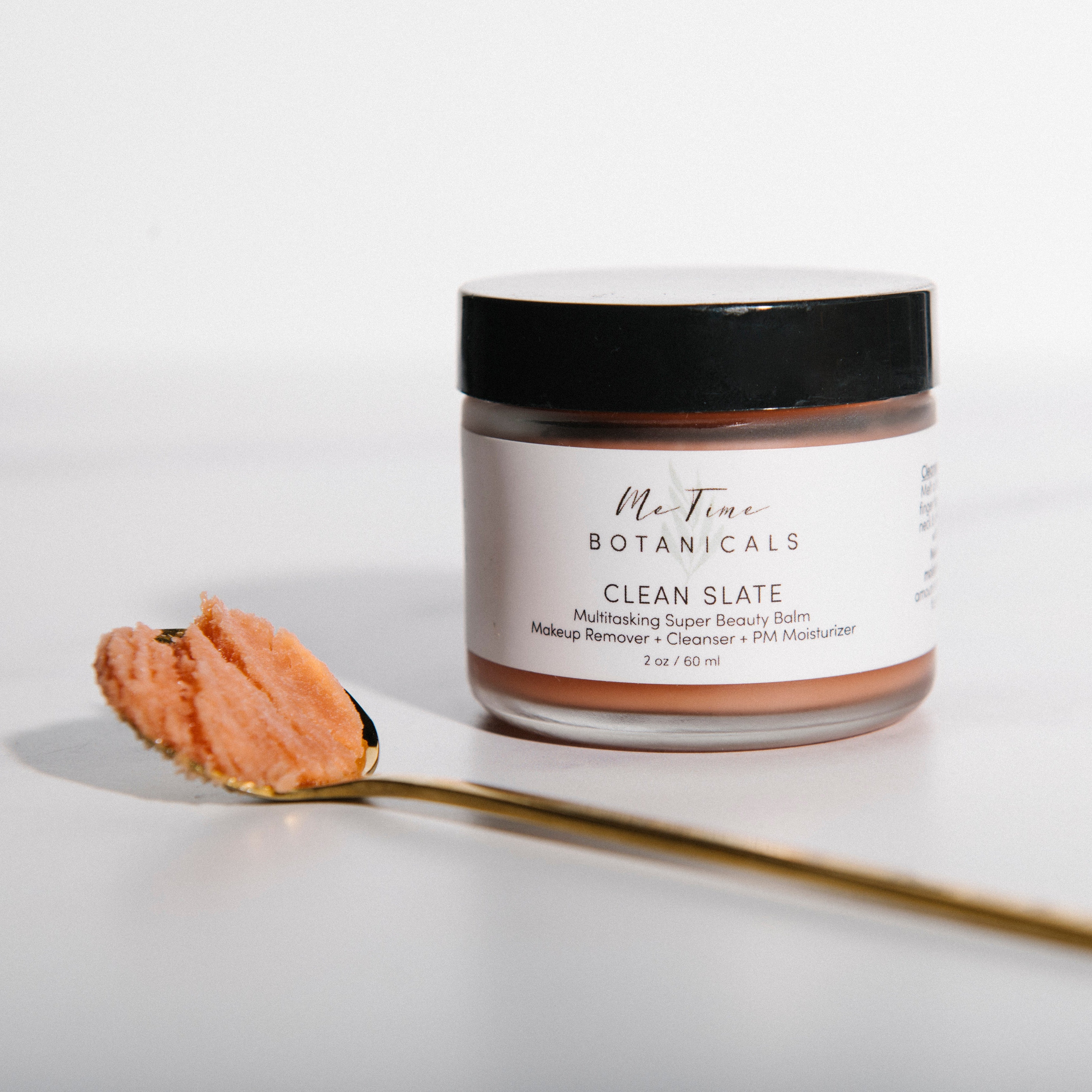 Jar of 'Clean Slate' product from Ole Tanin Botanicals with a spoonful of the product on a white background