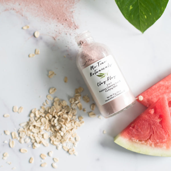 Bottle of clay mask with a label on a white background